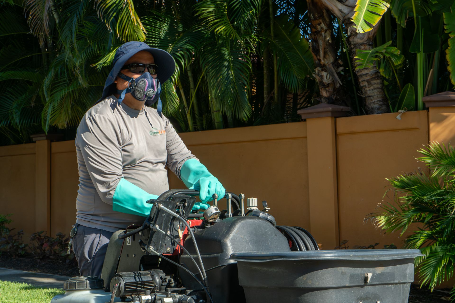 A GreenEdge staff member diligently applying pesticide in Bradenton. Our trained professionals follow strict guidelines and safety protocols to ensure effective pest control while minimizing environmental impact. Trust GreenEdge for expert pesticide application services that protect your property and promote a healthy outdoor environment.