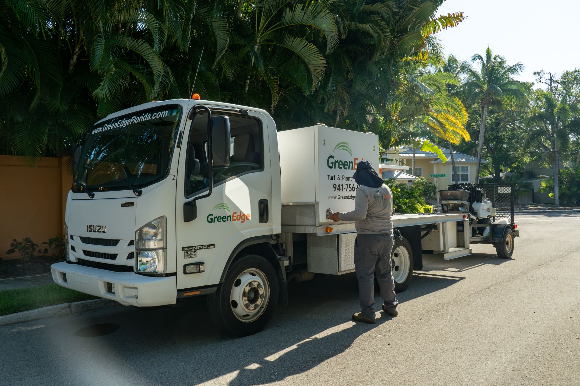 A GreenEdge staff member standing proudly beside the company truck in Sarasota. Our dedicated team utilizes the truck to efficiently transport equipment and materials for landscaping services. Trust GreenEdge for professional expertise and reliable service in maintaining and enhancing your outdoor spaces.