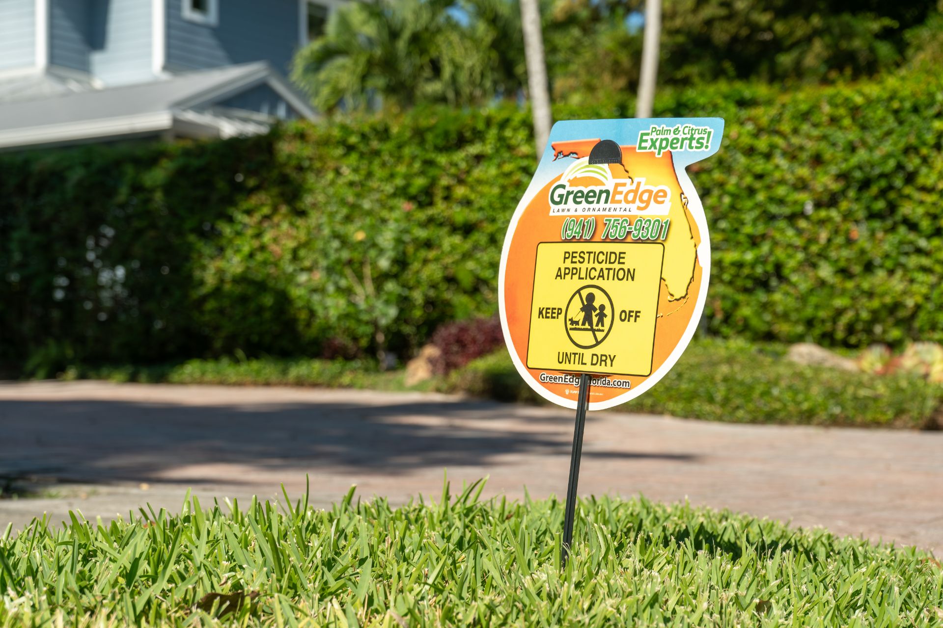 A sign placed in the grass by GreenEdge indicating that a pesticide has been applied. The sign states "Keep off until dry" as a safety precaution. We prioritize the well-being of our clients and adhere to proper application procedures to ensure effective and safe pesticide use. Trust GreenEdge for responsible and transparent practices in pest control services.