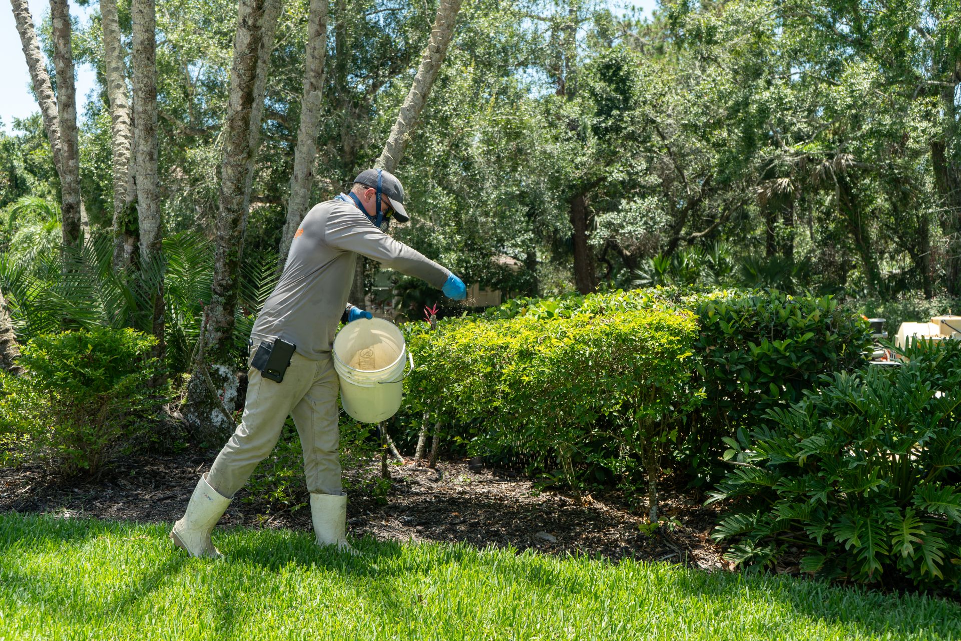 A GreenEdge staff member carefully applying fertilizer in a Sarasota home lawn. Our skilled team ensures precise and even distribution of nutrients to promote healthy plant growth. Trust GreenEdge for professional fertilizer applications that nourish and enhance the vitality of your landscape.