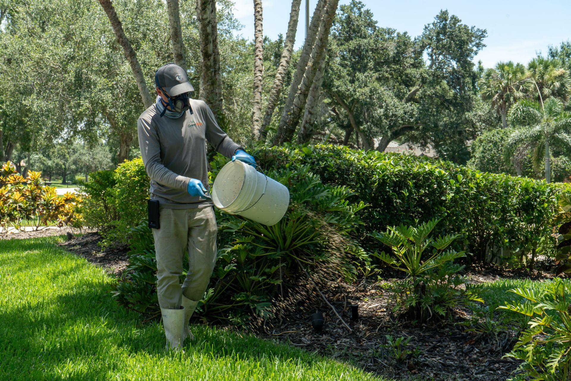 A GreenEdge staff member diligently working in proper uniform and wearing a mask in Sarasota. Our team prioritizes safety and follows strict protocols to ensure the well-being of our staff and clients. Trust GreenEdge for professional services delivered with utmost care and adherence to safety guidelines.