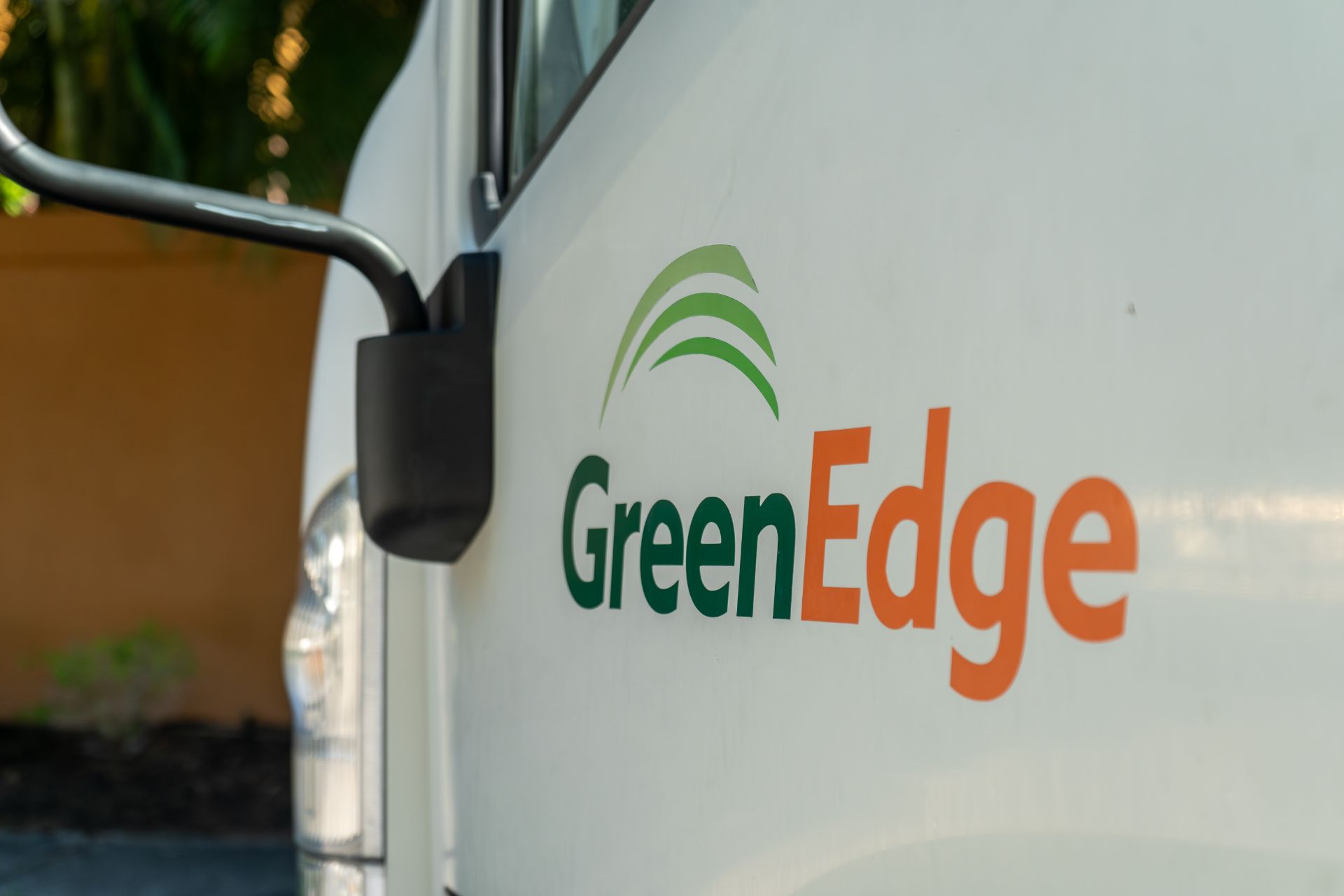 The GreenEdge logo prominently displayed on a company truck in Sarasota. Our logo represents our commitment to providing exceptional landscaping services, showcasing our expertise and dedication to quality. Trust GreenEdge for professional and reliable landscaping solutions that transform your outdoor spaces into stunning environments.