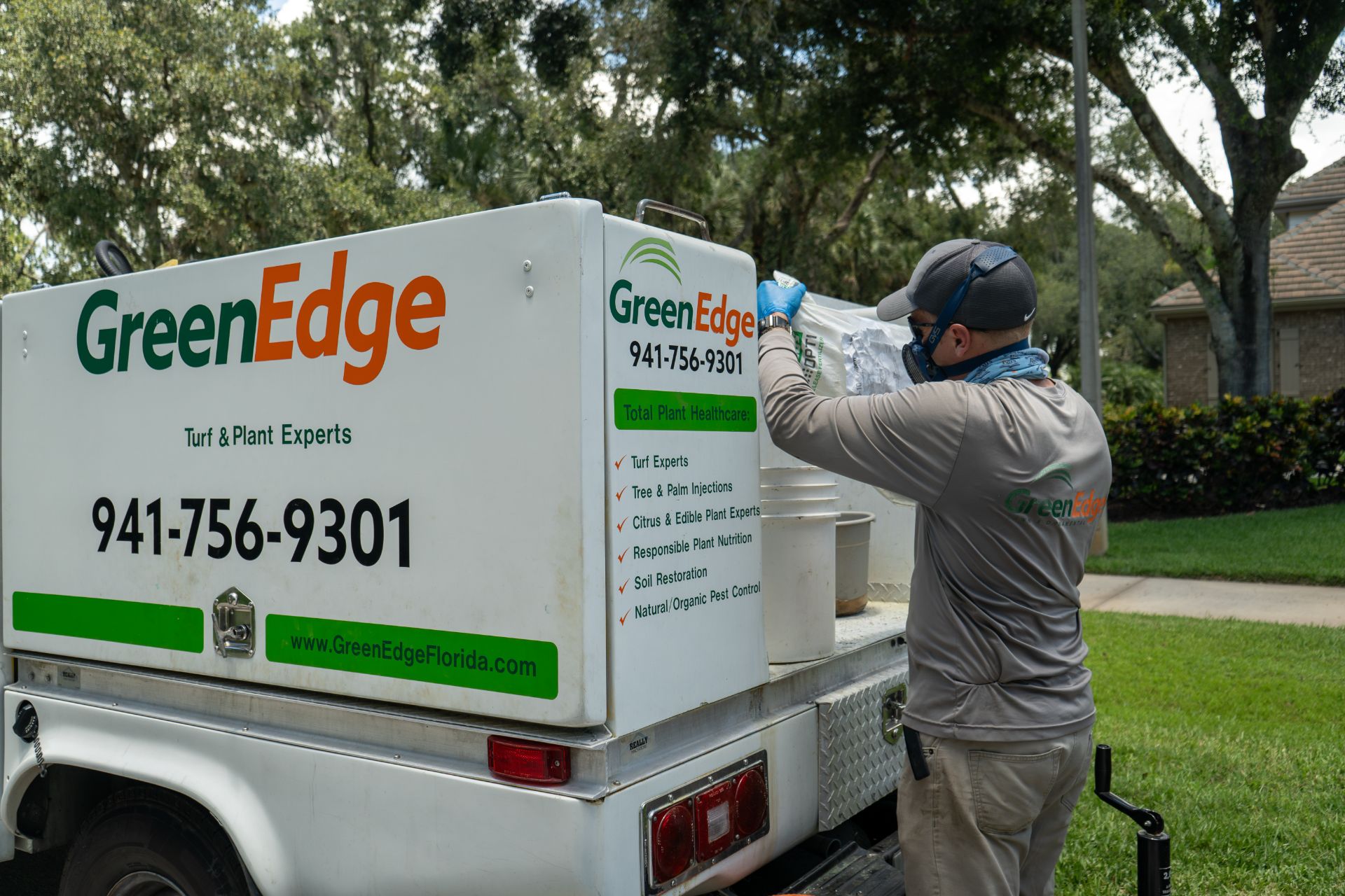A GreenEdge staff member proudly representing the company in a GreenEdge truck in Sarasota. Our dedicated team uses these vehicles as they provide efficient and reliable transportation to deliver our high-quality services. Trust GreenEdge for professional expertise and reliable service in maintaining and enhancing your outdoor spaces.